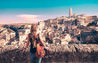 Tourist woman with bag looking at Matera town in Italy