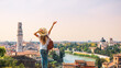 Tourist female enjoying beautiful view on Verona city in Italy