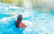 Woman relaxing in hot tub ( Saturnia in Italy)