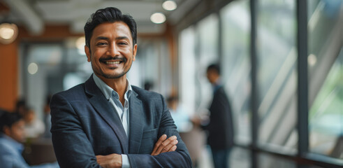 Wall Mural - A man in a suit is smiling and posing for a picture