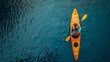 © Pavel Kachanau - A man kayaking on a lake, against a background of blue water. View from above.