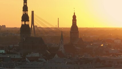 Wall Mural - Aerial panoramic sunset over Riga old town in Latvia. Beautiful spring sunset over Riga. Golden hour fire sunset.