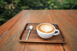White coffee cup and spoon on red wooden table