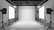 An empty photo studio with white walls and lighting equipment
