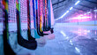 © shahrukh - A row of colorful hockey sticks leaning against the boards of an ice hockey rink, awaiting the start of a thrilling match between rival teams under the glow of arena lights.