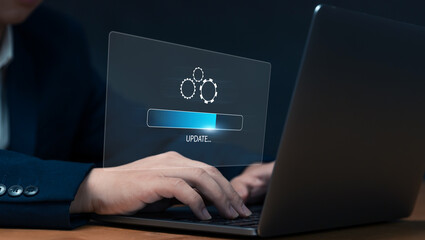Fototapete - Businessman updating computer system for device operating system to be up to date with new version. Graphics icon showing updating function screen loading on computer laptop.