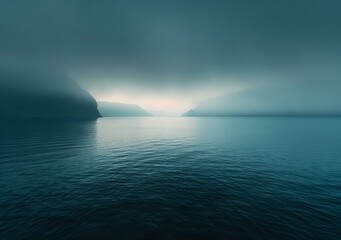 Wall Mural - Misty fjord landscape with dark blue water and mountains in the distance