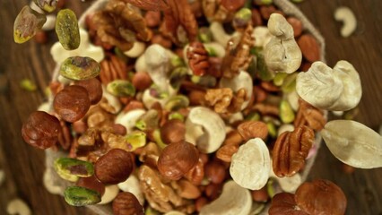 Poster - Super Slow Motion of Flying Nuts Mix into Jute Sack. Camera Tracking the Target. Filmed on High Speed Cinema Camera, 1000fps.