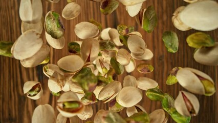 Poster - Super Slow Motion of Flying Pistachio Nuts over Wooden Planks. Camera Tracking the Target. Filmed on High Speed Cinema Camera, 1000fps.