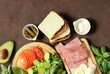 sandwich ingredients bread, ham, vegetables and sauce