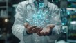 © pakbung - The image shows a scientist wearing a lab coat and holding a glowing blue molecule in their hands