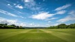 Serene cricket field set against a backdrop of rolling countryside and blue skies, the pitch pristine and ready for play