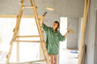 Woman painting while renovating a house