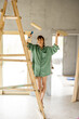 Woman painting while renovating a house