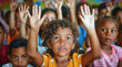 © Mix Creative - Children raise their hands to answer in the classroom. Back To School concept. Backdrop with selective focus