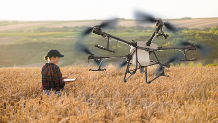 Aufkleber - Woman farmer controls drone sprayer with a laptop. Smart farming and precision agriculture.