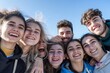 © yj - A group of friends smiling and posing for the camera, capturing their joyful expressions. The background is clear with a blue sky. an atmosphere of happiness among young people. generative AI