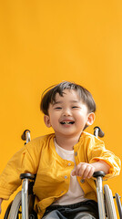 Wall Mural - smiling asian child in wheelchair on yellow background