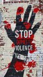 Stop domestic violence mural with red and black paint splashes on urban brick wall