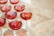 A collection of red wine glasses neatly arranged on a table for a gathering or event