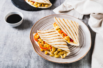 Canvas Print - Chicken quesadilla with corn and peppers wrapped in tortilla on a plate