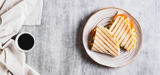 Poster - Chicken quesadilla with corn and peppers wrapped in tortilla on a plate top view web banner