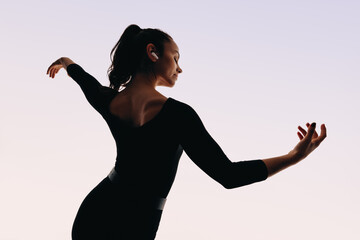 Expressive female dancer in dynamic performance with earphones