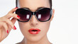 Fashionable woman in large sunglasses and red lipstick isolated on white, showcasing trendy eyewear
