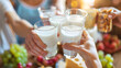 © Tanakorn - Diverse Group Savoring Dairy Delights in Joyful Gathering