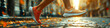 © Oleg - Morning jog along a city street. Generative AI. Women's feet in sneakers run along wet asphalt covered with fallen autumn leaves. Feet running in sports shoes. AI illustration