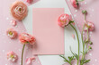 Greeting card mockup, empty  pink card with ranunculus flowers on pink background. top view flatlay. Card mockup with copy space. Mother's day, Birthday card
