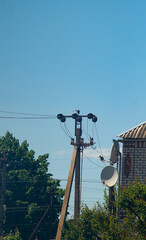 Electric pole near the house. Power line near the house