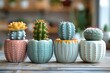 Decorative Cacti in Colorful Ceramic Pots on Wooden Table