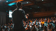 © Jioo7 - Male speaker giving a talk at business conference. Audience in the conference hall. Business and Entrepreneurship concept.