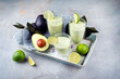 Traditional fruit smoothie with avocado, tropical juices and yoghurt served as close-up on a design stone board