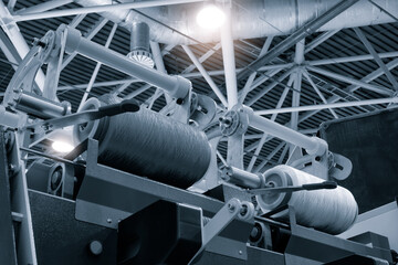 Poster - A machine with two rollers is in a factory