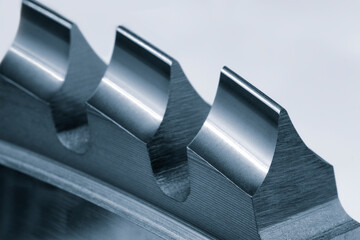 Poster - A close up of a metal piece with three ridges. The ridges are sharp and pointy, giving the piece a sharp and industrial look