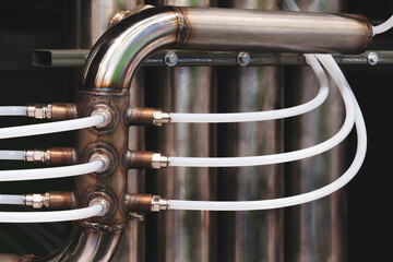 Aufkleber - A pipe with four white tubes attached to it. Concept of complexity and organization, as the tubes are arranged in a way that suggests a well-planned system