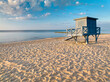 Lifeguard hut on beach at calm sunrise by Baltic Sea