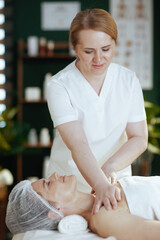 Poster - massage therapist massaging clients shoulder on massage table