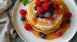 Stack of Pancakes With Berries and Syrup