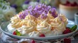 Cake With White Frosting and Purple Flowers on Plate