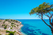 VILLAJOYOSA, ALICANTE, SPAIN, SEPTEMBER,8,2022: Panoramic view of the coast at the Caleta de Villajoyosa beach with some white buildings in the background on the cliffs on a sunny day.