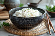 Bowl with boiled rice on table, closeup. Asian cuisine
