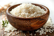 wooden bowl with boiled rice on table, closeup. Asian cuisine
