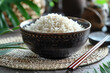 Bowl with tasty boiled rice on table, closeup. Asian cuisine