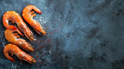 Wall Mural - Three cooked shrimps on dark textured background sprinkled with salt