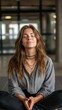 © ANC Media - A woman meditating in a yoga pose, eyes shut in relaxation
