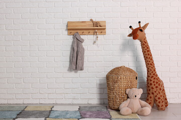 Wall Mural - Beautiful children's room with white brick wall and toys, space for text. Interior design