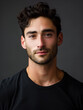 © MaleModels.AI - headshot of a handsome male model in his mid-twenties in a dark shirt with a dark background